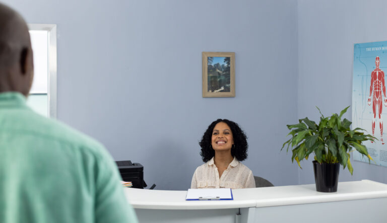 biracial-medical-receptionist-sitting-at-reception-2023-11-27-05-29-14-utc_a9vked-Hjju7f