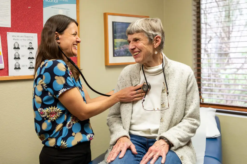 Dr. Jennifer Vazquez-Bryan listening to the breathing a patient