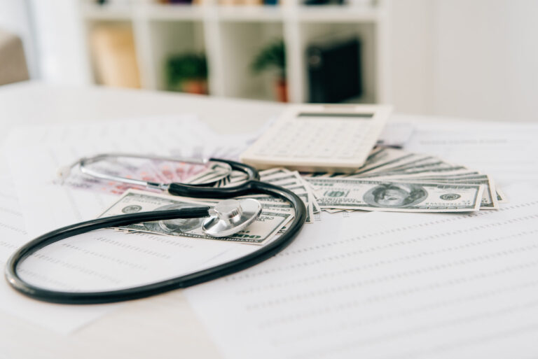 stethoscope-calculator-and-banknotes-on-table-in-2024-11-17-20-31-06-utc_bumzzg-miABs9