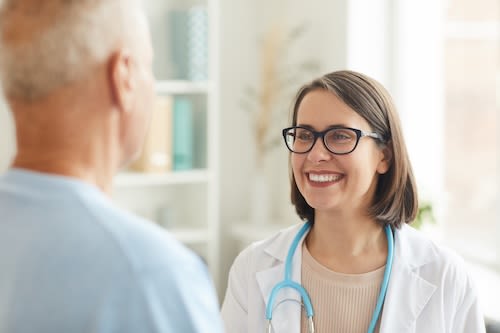 smiling-female-doctor-looking-at-senior-patient-2025-03-07-09-56-27-utc_q75bg3-7ORvr3