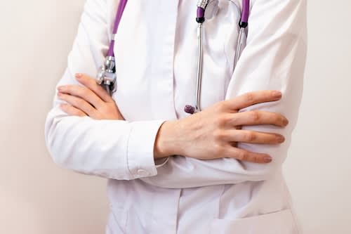 doctor-in-uniform-stands-with-her-arms-folded-unde-2025-01-09-03-23-31-utc_bpt6vi-xjyjx9