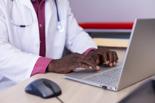 midsection-of-african-american-male-doctor-sitting-2025-04-04-01-57-09-utc_raovpp-cysIwR