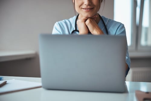 smiling-female-doctor-using-laptop-in-clinic-2026-01-05-06-13-26-utc_albmqi-OqbGUF